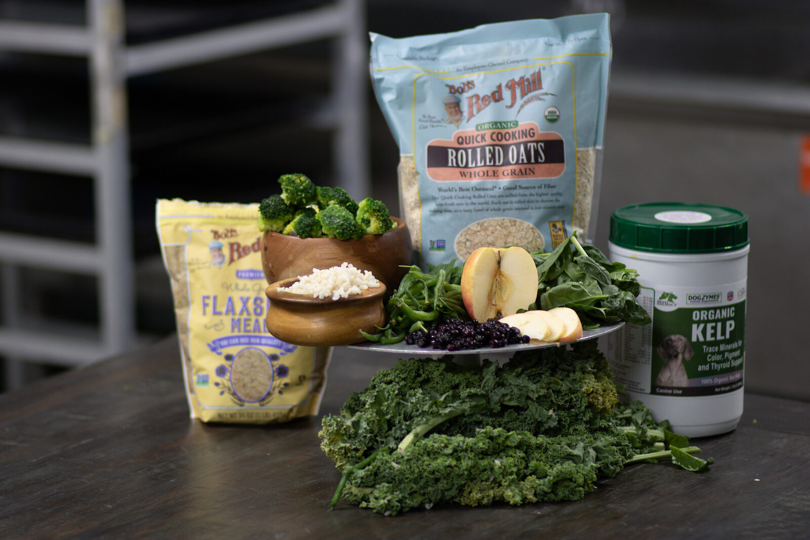 Fresh whole-food ingredients: rolled oats, kale, apples, and organic kelp